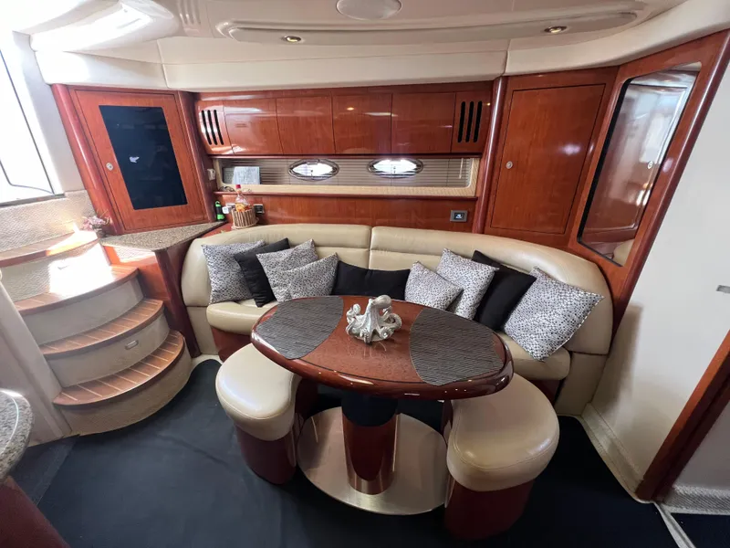 Slide: The Image of Luxurious 2005 Sea Ray 420 Sundancer yacht interior with elegant seating and wooden cabinetry. - 49