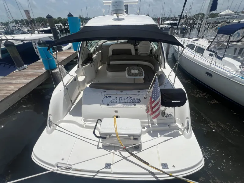 Slide: The Image of 2005 Sea Ray 420 Sundancer docked at marina with American flag and canopy. - 6