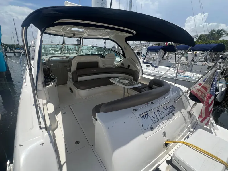 Slide: The Image of 2005 Sea Ray 420 Sundancer yacht with spacious seating and canopy in marina. - 7