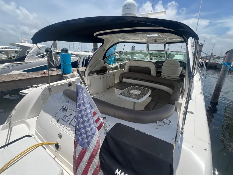 Slide: The Image of 2005 Sea Ray 420 Sundancer yacht with American flag, docked at marina. - 9