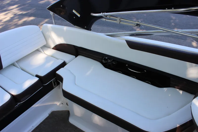 Slide: The Image of 2016 Regal 2500 Bowrider interior seating area with white and black upholstery. - 40