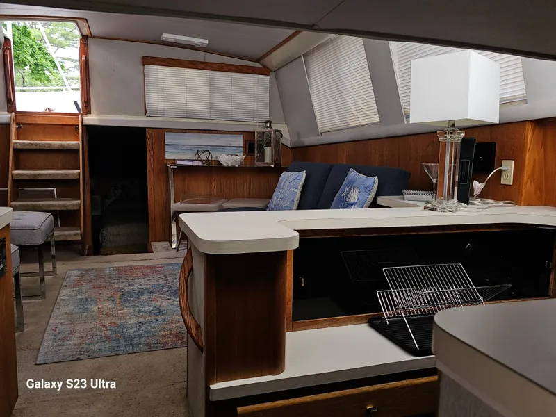 Slide: The Image of Interior of 1989 Silverton 40 Aft Cabin yacht with cozy seating and modern decor. - 10