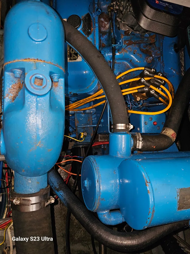 Slide: The Image of Engine components of a 1989 Silverton 40 Aft Cabin boat, featuring blue machinery. - 22