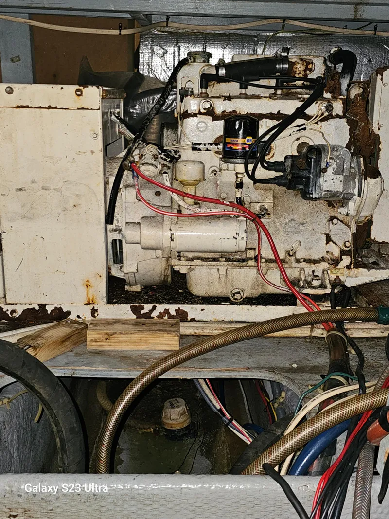 Slide: The Image of Engine compartment of a 1989 Silverton 40 Aft Cabin boat, showing mechanical components. - 25