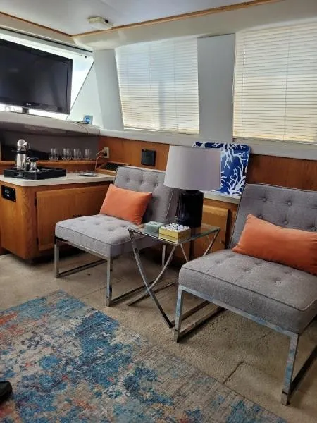 Slide: The Image of 1989 Silverton 40 Aft Cabin interior with modern seating, TV, and decor. - 35