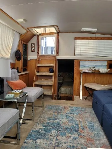 Slide: The Image of Interior of a 1989 Silverton 40 Aft Cabin yacht with cozy seating and nautical decor. - 37