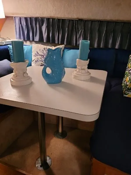 Slide: The Image of 1989 Silverton 40 Aft Cabin interior with table, blue decor, and cushioned seating. - 38