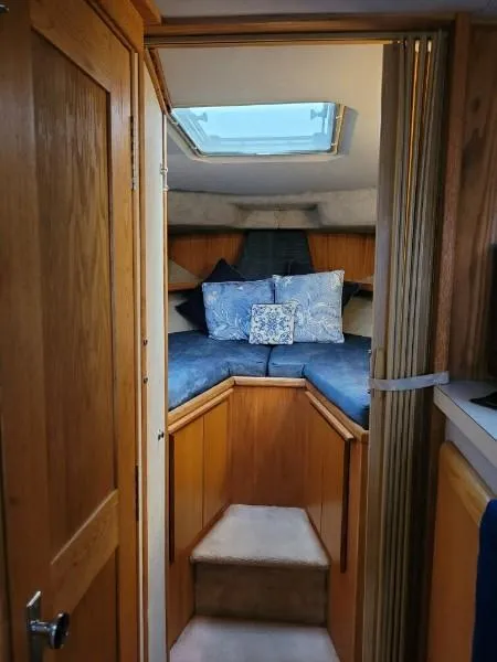 Slide: The Image of 1989 Silverton 40 Aft Cabin interior with cozy bedding and wooden accents. - 39