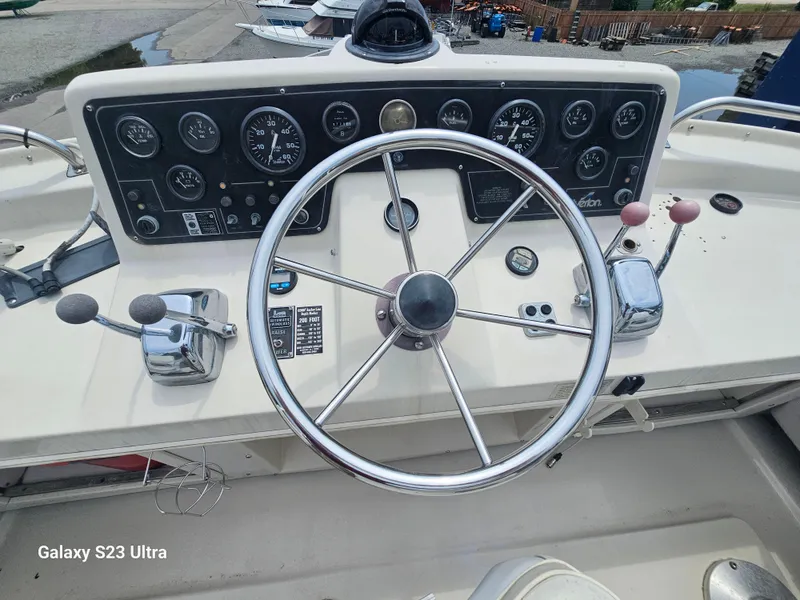 Slide: The Image of 1989 Silverton 40 Aft Cabin helm with steering wheel and control panel. - 4