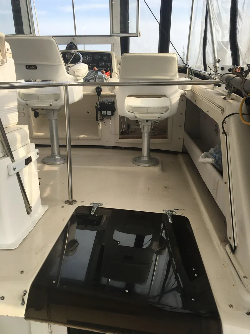 Slide: The Image of 1989 Silverton 40 Aft Cabin boat interior with helm and seating area. - 7
