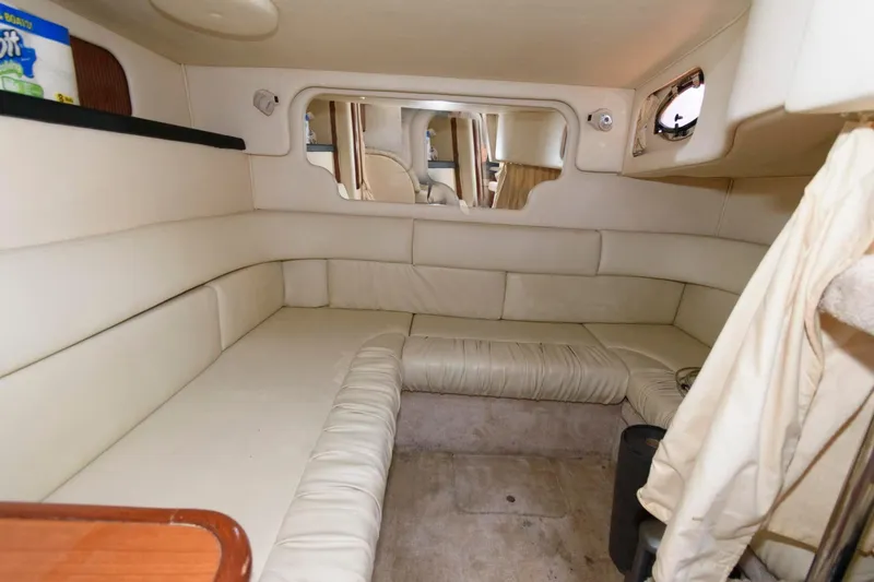 Slide: The Image of 1999 Sea Ray 340 Sundancer cabin interior with beige leather seating. - 13