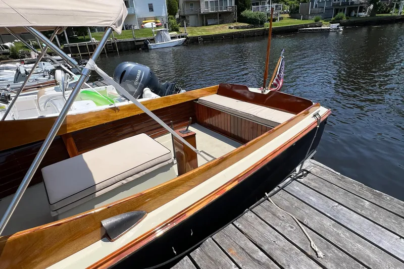 Slide: The Image of 1952 Custom Palmer Scott 22 boat docked by a wooden pier on a sunny day. - 12