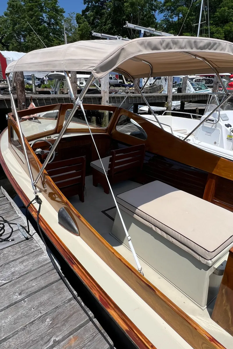 Slide: The Image of 1952 Custom Palmer Scott 22 boat with canopy, docked at marina. - 13