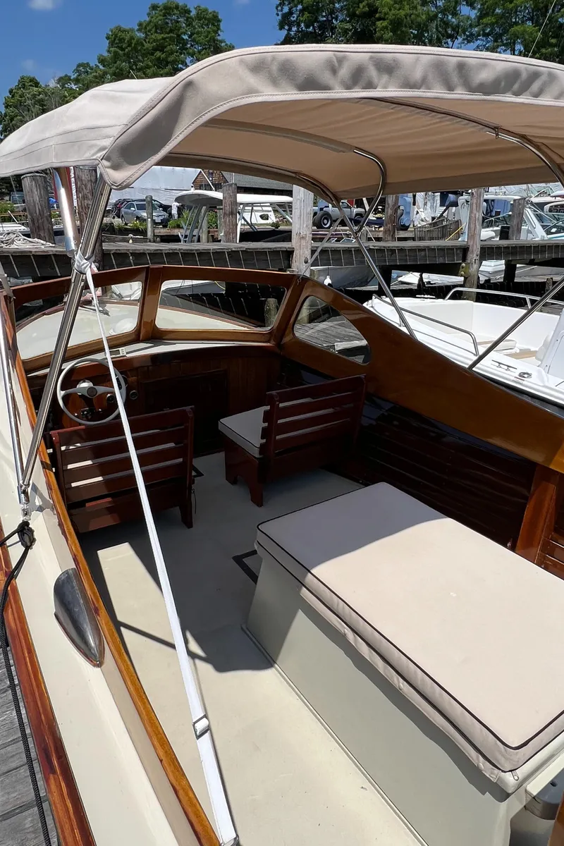 Slide: The Image of 1952 Custom Palmer Scott 22 boat with canopy, docked at marina. - 6