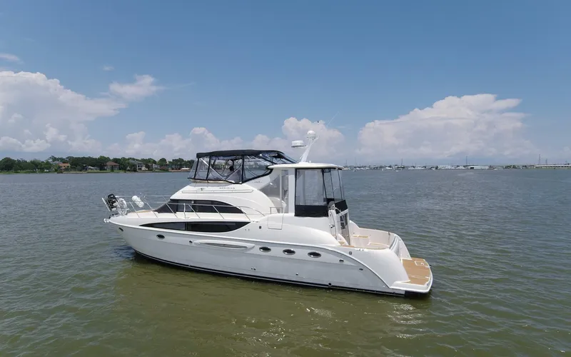 Slide: The Image of 2007 Meridian 459 Motor Yacht cruising on a calm lake under a clear sky. - 43