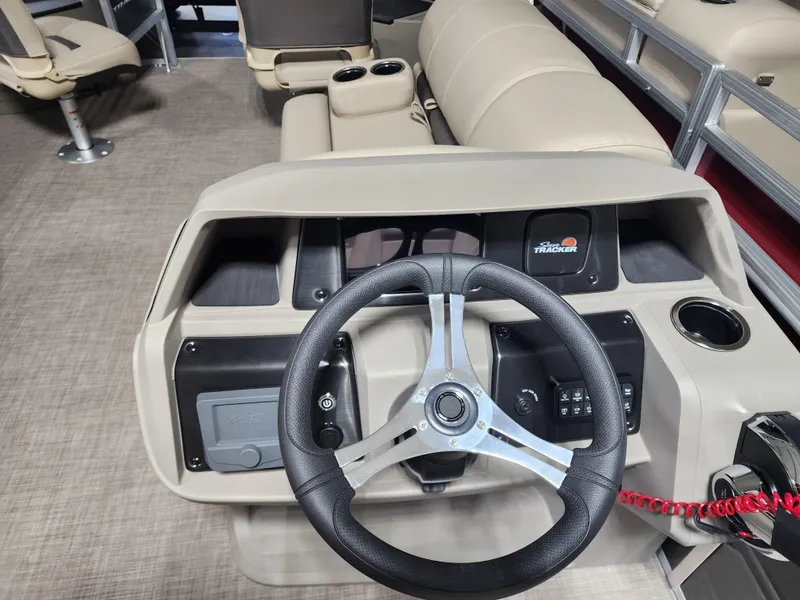Slide: The Image of 2024 Sun Tracker Fishin' Barge 20 DLX steering console with modern controls and seating. - 10