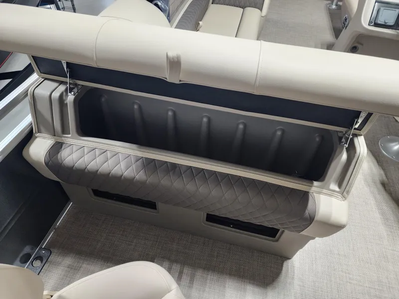 Slide: The Image of 2024 Sun Tracker Fishin' Barge 20 DLX interior storage compartment with cushioned seating. - 14