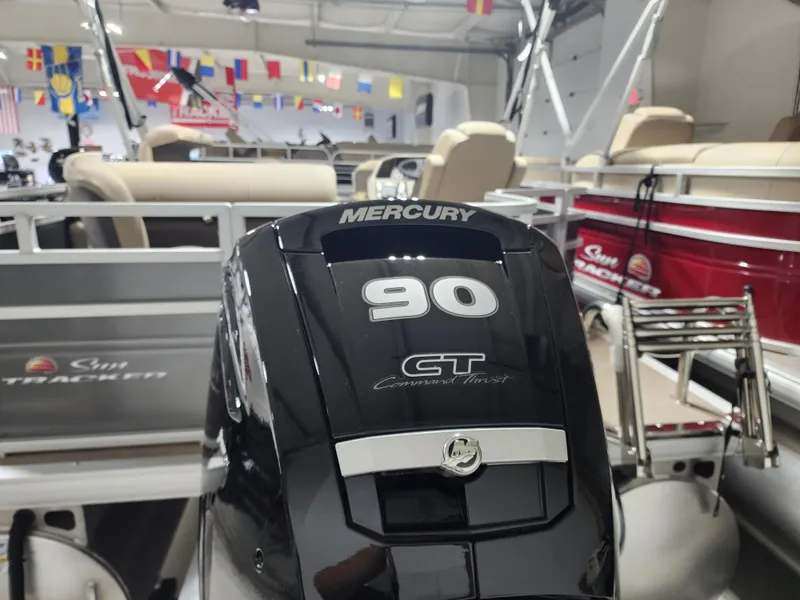 Slide: The Image of 2024 Sun Tracker Fishin' Barge 20 DLX with Mercury 90 GT engine in showroom. - 15