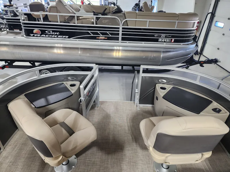 Slide: The Image of 2024 Sun Tracker Fishin' Barge 20 DLX interior with seating and console view. - 3