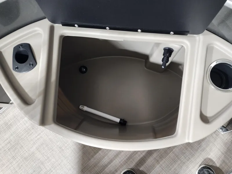 Slide: The Image of 2024 Sun Tracker Fishin' Barge 20 DLX storage compartment with cup holders and pen. - 4