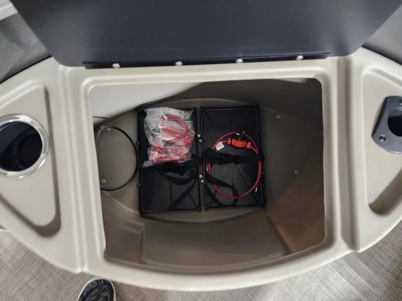 Slide: The Image of Storage compartment of 2024 Sun Tracker Fishin' Barge 20 DLX with battery holders. - 5