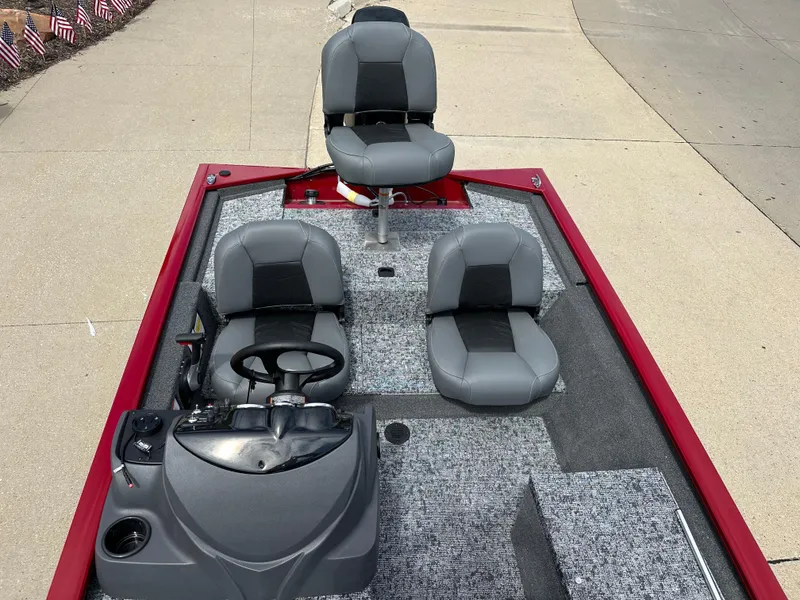 Slide: The Image of 2024 Tracker Pro 170 boat interior with three gray seats and steering console. - 5