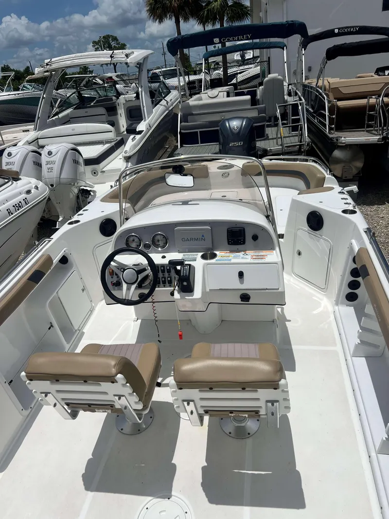Slide: The Image of 2020 Hurricane 231 SS boat interior with dual seats and Garmin navigation system. - 4