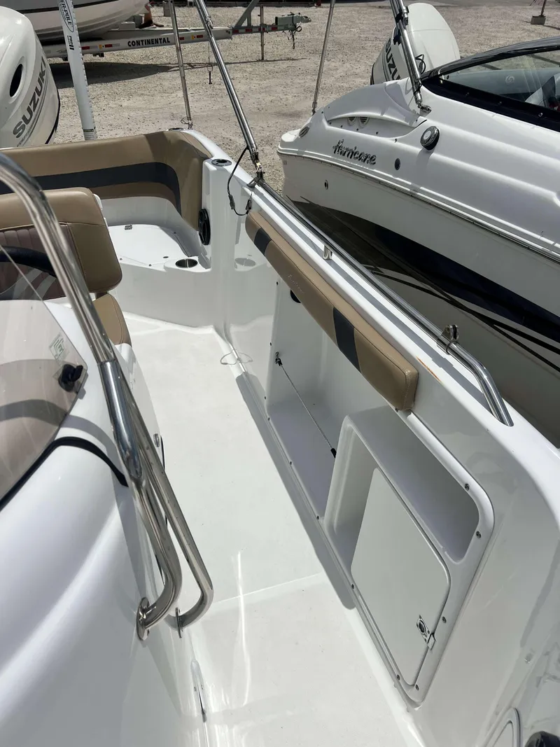 Slide: The Image of 2020 Hurricane 231 SS boat interior with seating and storage compartments. - 6