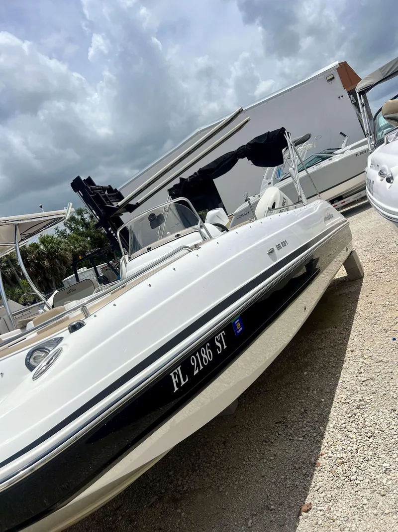 Slide: The Image of 2020 Hurricane 231 SS boat in storage yard under cloudy sky. - 8