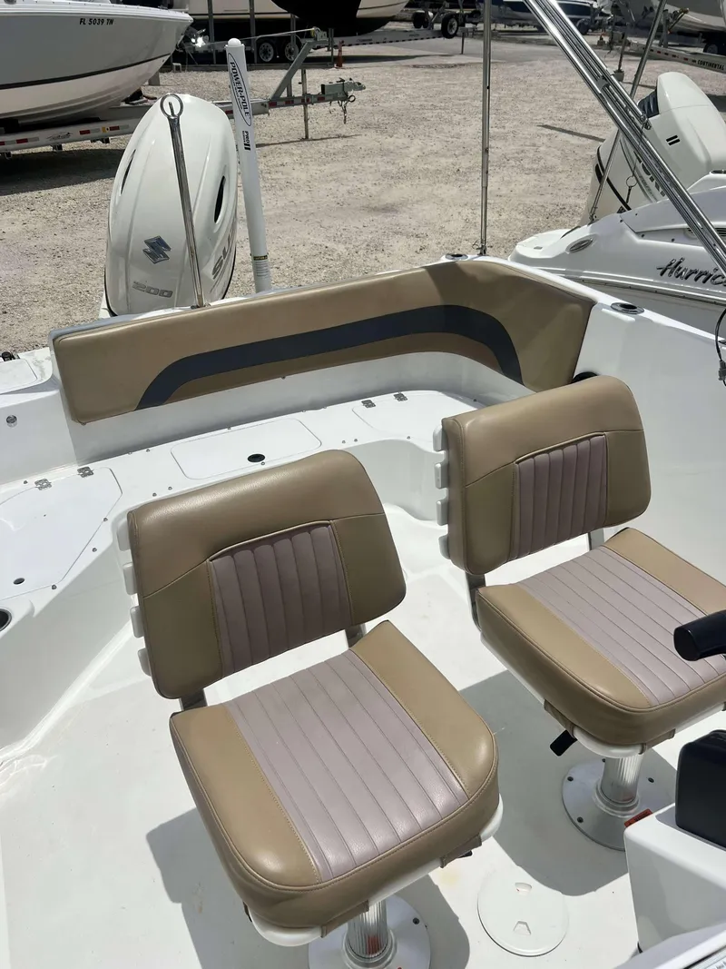 Slide: The Image of 2020 Hurricane 231 SS boat interior with dual tan and gray seats. - 9