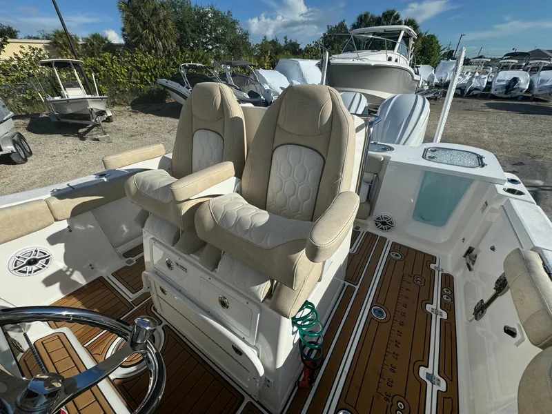Slide: The Image of 2022 Sea Fox 288 Commander boat interior with dual captain's chairs and teak flooring. - 10