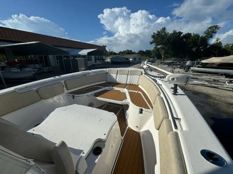 Slide: The Image of 2022 Sea Fox 288 Commander boat interior with cushioned seating and wood flooring. - 7