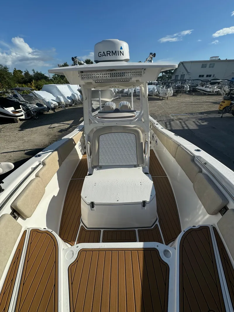Slide: The Image of 2022 Sea Fox 288 Commander boat with Garmin navigation system, teak flooring, and cushioned seating. - 8