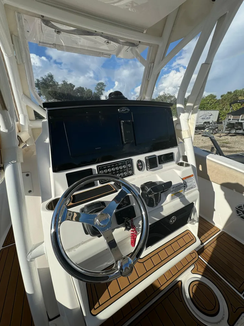 Slide: The Image of Sea Fox 288 Commander 2022 boat helm with steering wheel and control panel. - 9