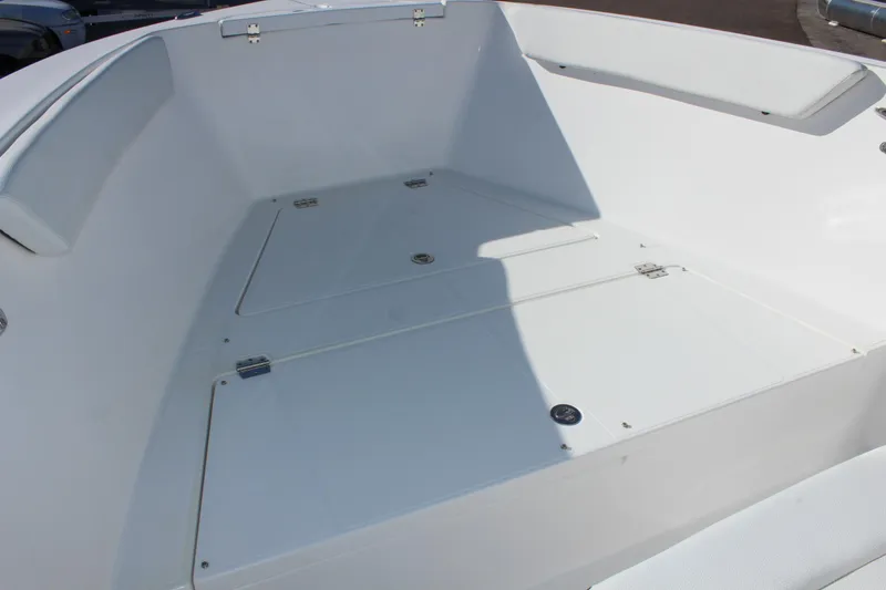 Slide: The Image of 2024 Clearwater 2300 WI boat interior with spacious deck and storage compartments. - 11