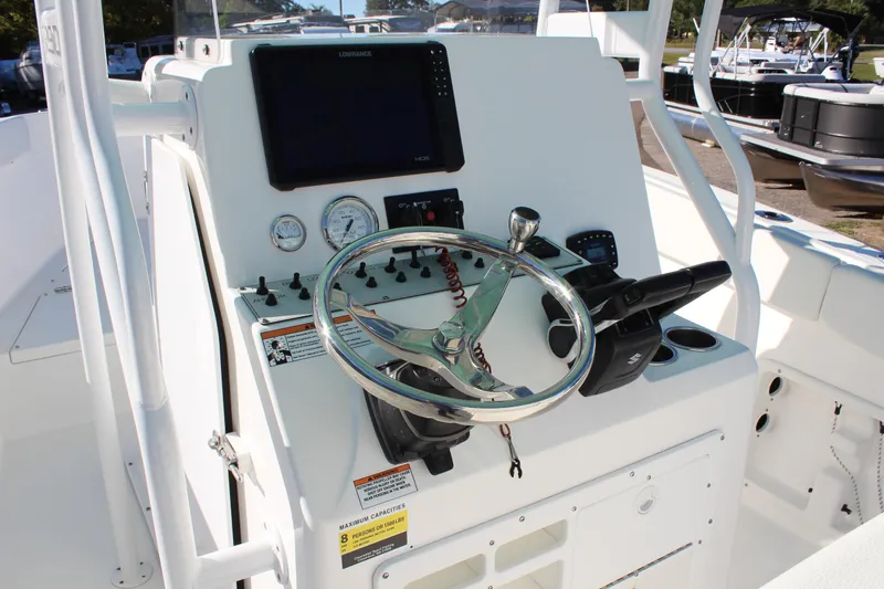 Slide: The Image of 2024 Clearwater 2300 WI boat console with steering wheel and navigation controls. - 18