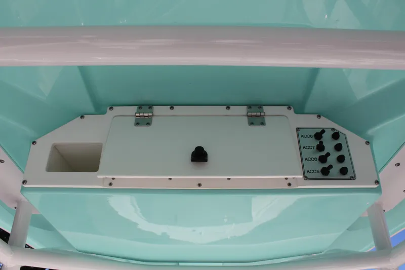Slide: The Image of Control panel of 2024 Clearwater 2300 WI boat with switches and storage compartment. - 19