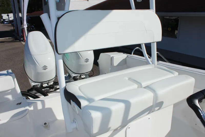 Slide: The Image of Clearwater 2300 WI 2024 boat with dual Suzuki outboard motors and white seating. - 22