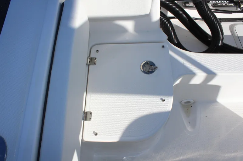 Slide: The Image of 2024 Clearwater 2300 WI boat storage compartment with latch. - 23
