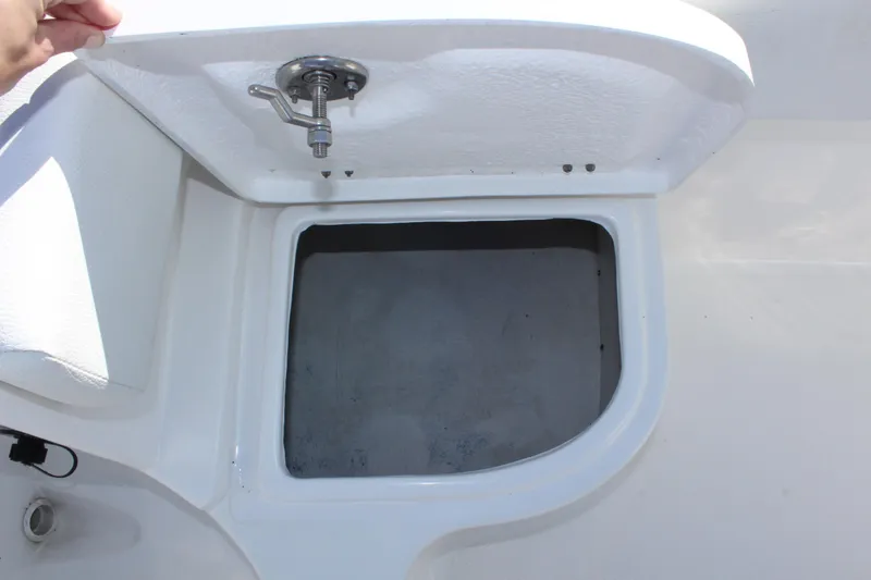 Slide: The Image of Open storage compartment on a 2024 Clearwater 2300 WI boat. - 25