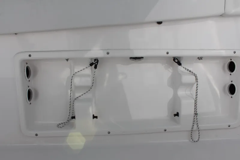 Slide: The Image of 2024 Clearwater 2300 WI boat transom with storage compartments and securing ropes. - 29