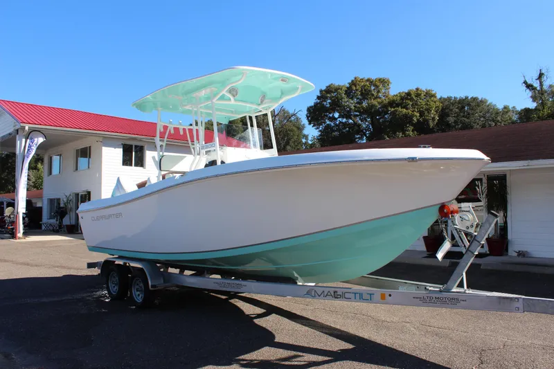 Slide: The Image of 2024 Clearwater 2300 WI boat on a trailer outside a building. - 3