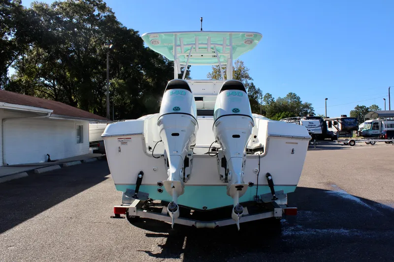 Slide: The Image of 2024 Clearwater 2300 WI boat with dual outboard engines, rear view. - 5