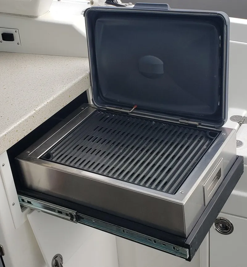 Slide: The Image of Built-in grill on 2016 Monterey 360 Sport Coupe yacht, open lid, sleek design. - 20