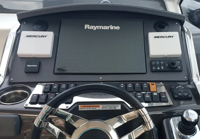 Slide: The Image of 2016 Monterey 360 Sport Coupe dashboard with Raymarine and Mercury controls. - 3