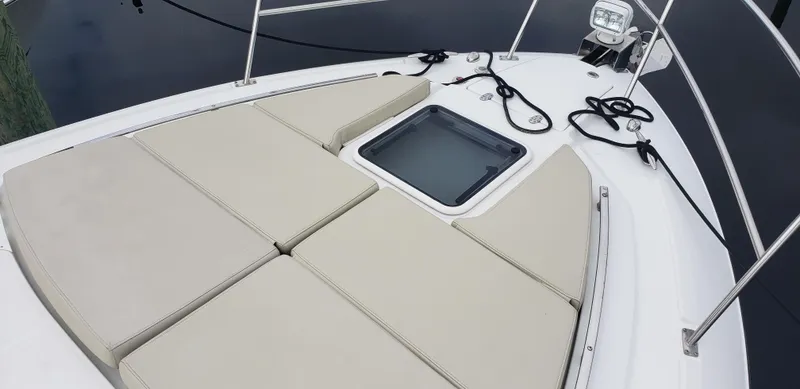 Slide: The Image of 2016 Monterey 360 Sport Coupe boat deck with cushioned seating and hatch. - 34