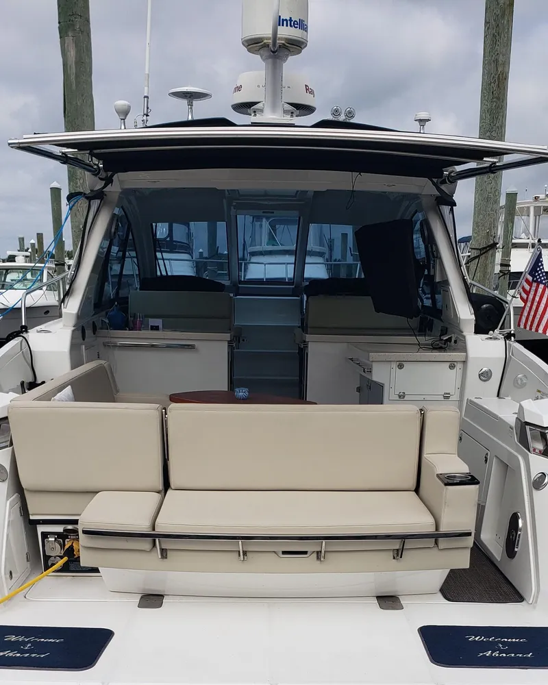Slide: The Image of 2016 Monterey 360 Sport Coupe yacht with beige seating at a marina. - 40