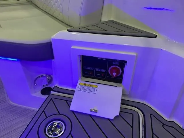 Slide: The Image of 2024 Sea Ray SDX 250 boat control panel with seating and blue LED lighting. - 10