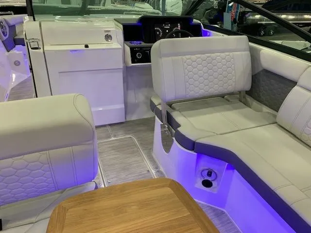 Slide: The Image of 2024 Sea Ray SDX 250 boat interior with white seating and blue accent lighting. - 4
