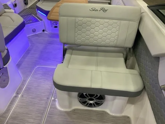 Slide: The Image of 2024 Sea Ray SDX 250 boat interior with cushioned seating and ambient lighting. - 6